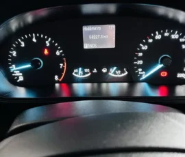 Car dashboard with speedometer and tachometer, central display shows 58,227.3 km and gear PRNDS; temperature 17°C; warning lights illuminated.