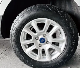 Close-up of a Ford alloy wheel with a mounted tire on a white vehicle