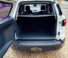 Open SUV cargo area with tailgate up; empty black luggage space, rear seats visible, Nilson Car logo on bumper.