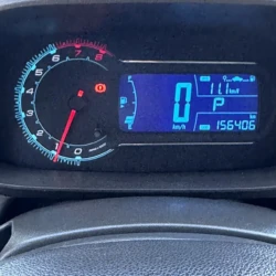 Car dashboard: tachometer on left, digital display showing 0 km/h, P gear, fuel gauge, and odometer reading 156,406 km