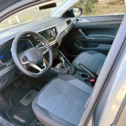 Interior of a Volkswagen car: steering wheel, center console, and gray fabric seats.